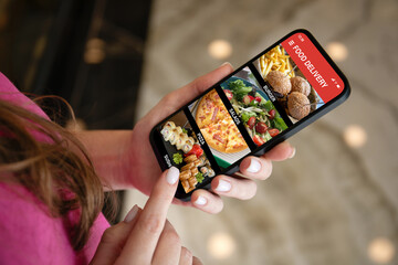 Woman hands holding phone with food delivery app on screen
