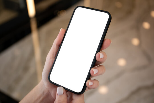 Female hands hold phone with isolated screen on background street