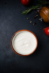 Sour cream sauce in a small ceramic bowl.