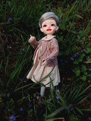 bjd doll smiling child in a garden