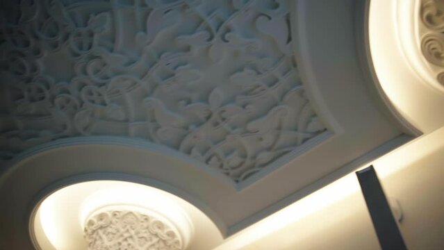 White painted columns. Scene. Beautiful architecture inside the room and beautiful carved patterns on the walls.