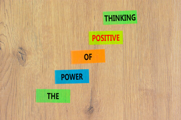 Positive thinking symbol. Concept words The power of positive thinking on colored paper. Beautiful wooden table wooden background. Business, motivational positive thinking concept. Copy space.