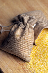 Linen bag of small size with dry corn flour for cooking porridge