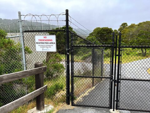 No Trespassing Sign With Barbed Wire Fence and Gate at Crystal Springs Water Reservoir of Hetch Hetchy System in San Mateo County, San Francisco Bay Area, California near San Andreas Fault