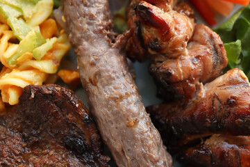 Braaied meat. South African barbecue meat including boerewors, lamb chops and chicken kebabs 
