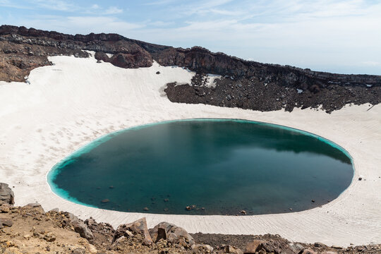 Gorely Volcano crater lake with Mutnovsky Volcano on the background. Kamchatka, Russia