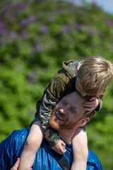 A kid and his dad playing in summer time