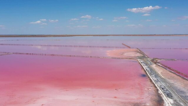 Above pink salt lake with microalgae Dunaliella salina. Famous for its antioxidant properties, enriching water by beta-carotene, used in medicine, dermatology and spa. Salt production facilities pond.
