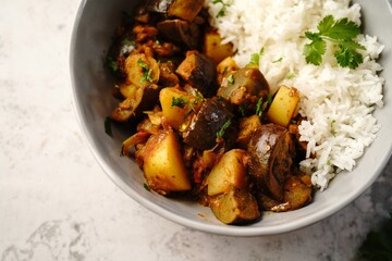 Aloo Baingan or Eggplant  potato masala served with rice - Indian vegetarian dishes