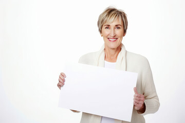 Fototapeta premium Senior woman holding a blank white sheet of paper on a white background