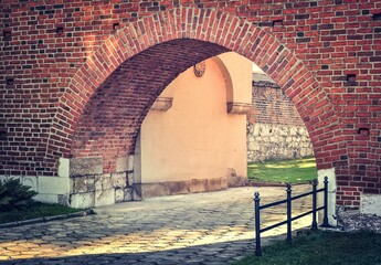 Covered way in the town. Footpath with archway made of brick. Photo taken in Krakow, Poland.