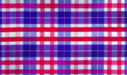 The texture of linen fabric in a large cell of red and blue. Scottish tailoring material