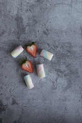 On a beautiful background of marshmallows and strawberries. View from above.