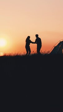 The romantic couple have fun on the mountain top above the sea