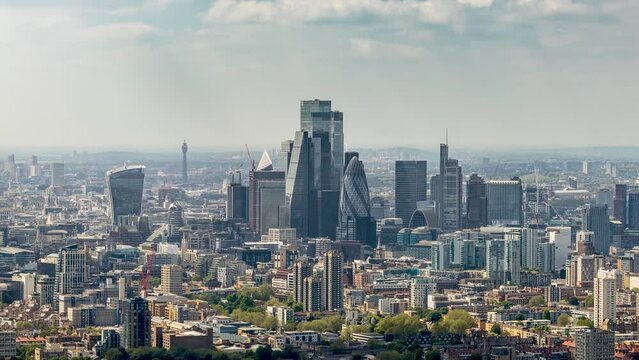 Elevated time lapse view of the skyscrapers at the City of London, England, during a sunny day with clouds