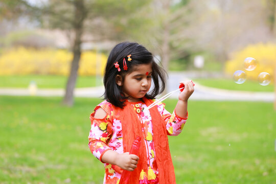 Picture of young girl with deshi dress playing bubbles