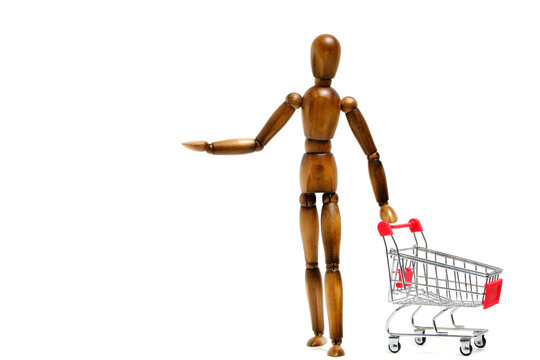 Brown mannequin stands in front shopping cart.Concept going supermarket and to store.