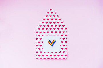 Envelope in the shape of house with LGBTQ heart. Friendly home love acceptance family all gender are welcome. growth up with happy pride and freedom in the community. Rainbow flag house concept