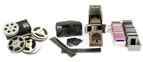 Photo camera, film, projector and slides isolated on white background. Collage. Wide photo.