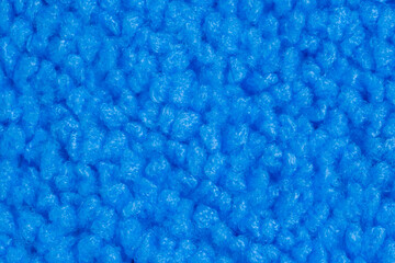 Top view: blue microfiber cleaning cloth - close up, macro. Texture, abstract, pattern, background and cleaning equipment for housework concept