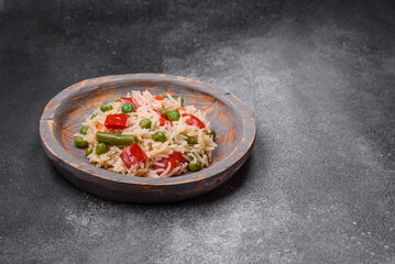 Delicious boiled rice with peppers, peas, asparagus beans and carrots