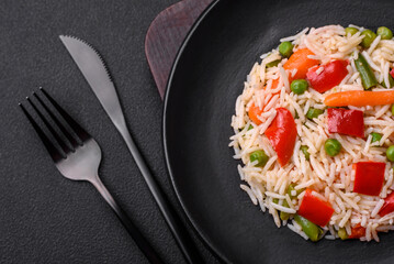 Delicious boiled rice with peppers, peas, asparagus beans and carrots