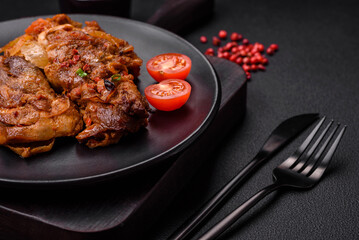 Delicious fried chicken in sauce with onions, salt, spices and herbs