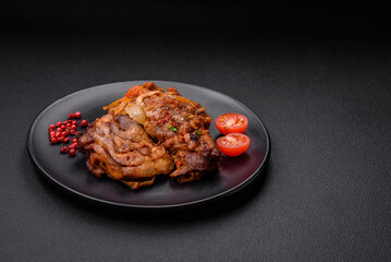 Delicious fried chicken in sauce with onions, salt, spices and herbs