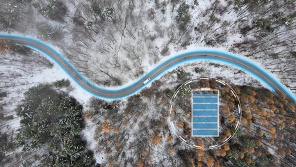 Electric car driving on a snowy forest road, battery performance decreasing in cold, winter conditions - added graphics - Powered by Adobe