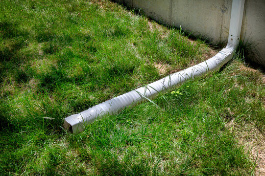 Gutter downspout, flexible rain gutter extension next to house 