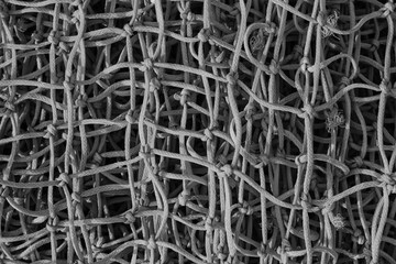 close-up of a gray rope net. Rope weave texture. Black and white photography
