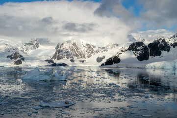 Snowed mountains at the antarctica. glaciers and ice melting due to climate change