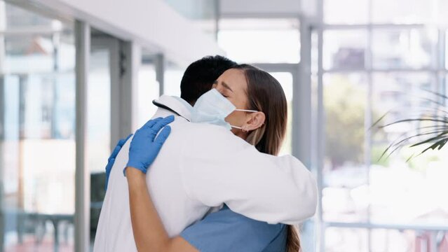 Doctor, sad woman and crying with hug in support for grief, loss or failed surgery at the hospital. Upset or unhappy female medical professional hugging surgeon after bad news or failure at clinic