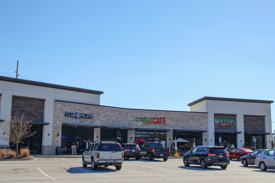 Club Pilates McAlisters store and parking lot strip mall with cars