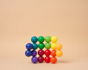 Abstract background with multi-colored plastic balls on a beige background, a stage for the demonstration of cosmetics and products