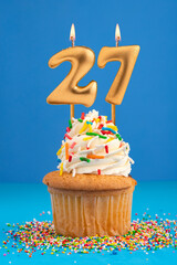 Birthday cake with candle number 27 - Blue background