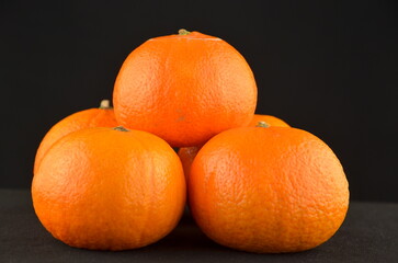 A group of tangerines on a black background