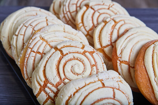 Vanilla white concha frosting with sea shell pattern Mexican sweet bread baked good tray conchas