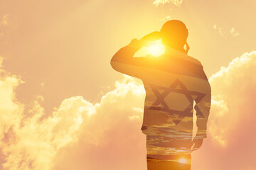 Double exposure of Silhouette of a solider and the sunset or the sunrise against Israel flag....