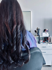 Brunette girl in a beauty salon. Beauty saloon. Soft focus