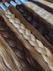 Hair extensions are on the table. Natural hair. Capsule hair extension. Beauty salon. Soft focus