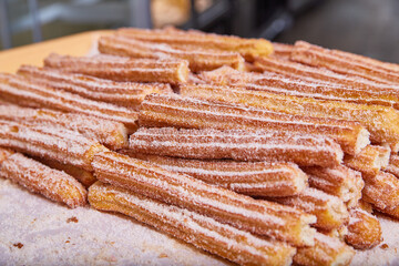 Tray of churros a star-shaped Mexican baked good pastry coated in cinnamon sugar