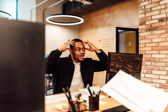 Confused and stressed businessman at work in office