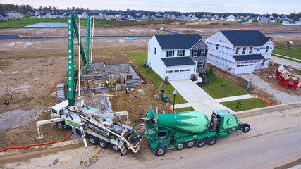 Cement Truck pour aerial residential home, house foundation build outline of building - obrazy, fototapety, plakaty