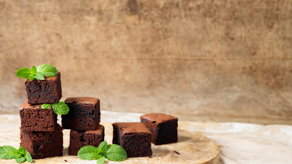 Chocolate brownie with mint on top with blurred background. Generative AI.
