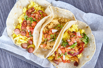 Three Hispanic breakfast tacos bacon sausage chorizo eggs on white simple background asset