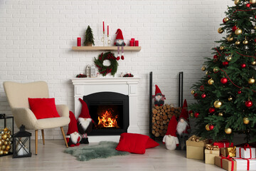 Beautiful Christmas themed photo zone with tree and fireplace in room