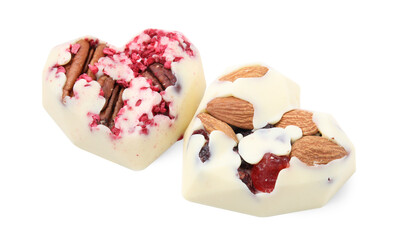 Tasty chocolate heart shaped candies with nuts on white background