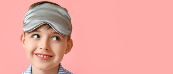 Happy little boy with sleep mask on pink background with space for text