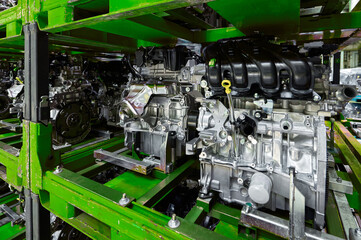 Car internal combustion engines stand on racks in warehouse